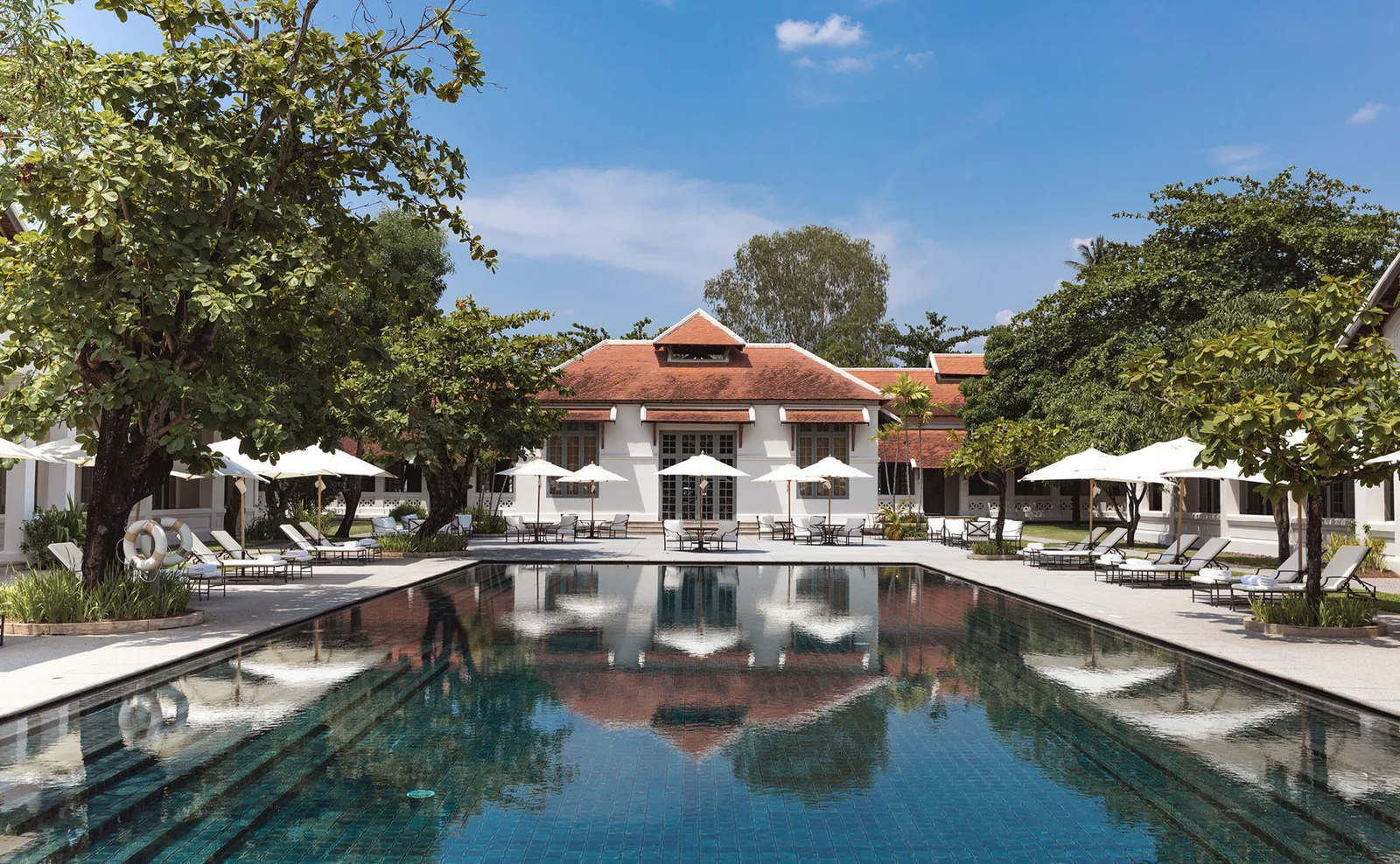 Amantaka's reflecting pool and restored colonial-era courtyard buildings in Luang Prabang