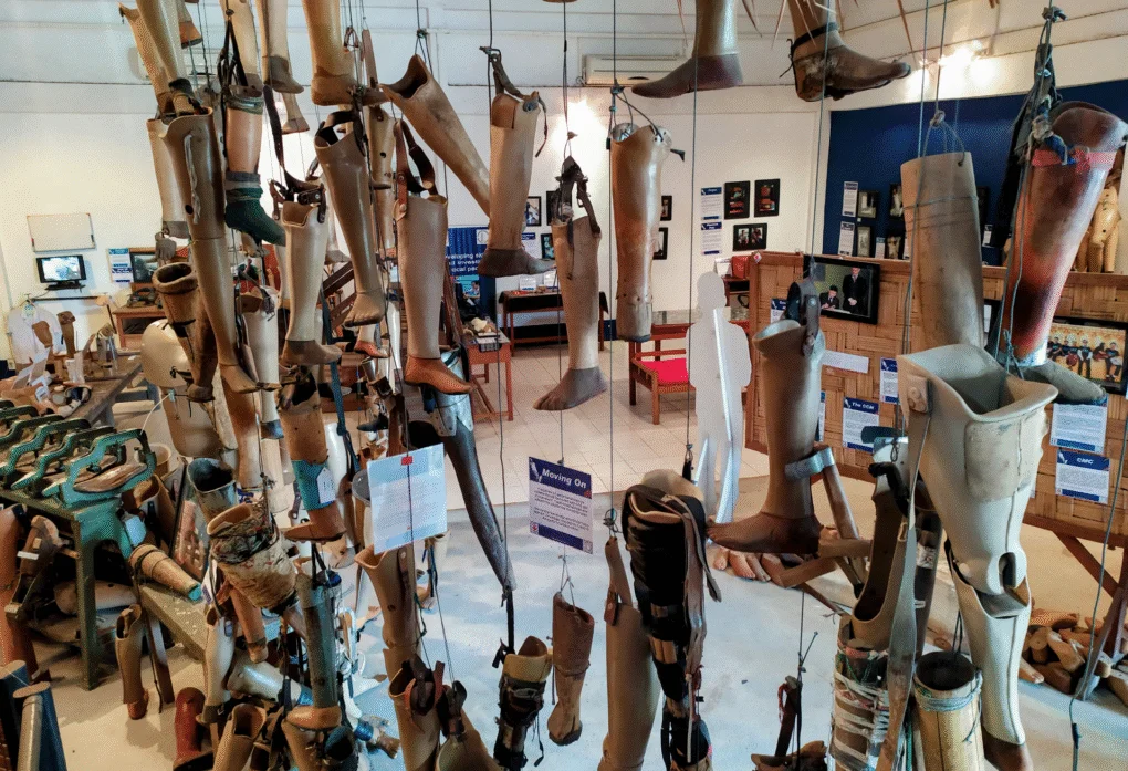 Vientiane, Laos: A Three-Day Pause in the Universe 6 Hanging prosthetic limbs on display inside the COPE Visitor Centre in Vientiane, part of the UXO survivor exhibition